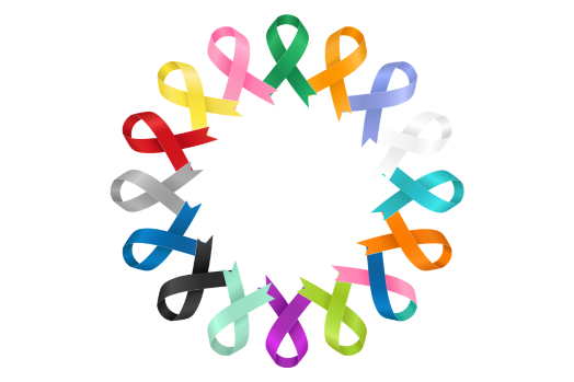 A circular arrangement of colorful satin ribbons tied in loops around a white center, with multiple shades including pink, green, orange, blue, purple, and yellow.